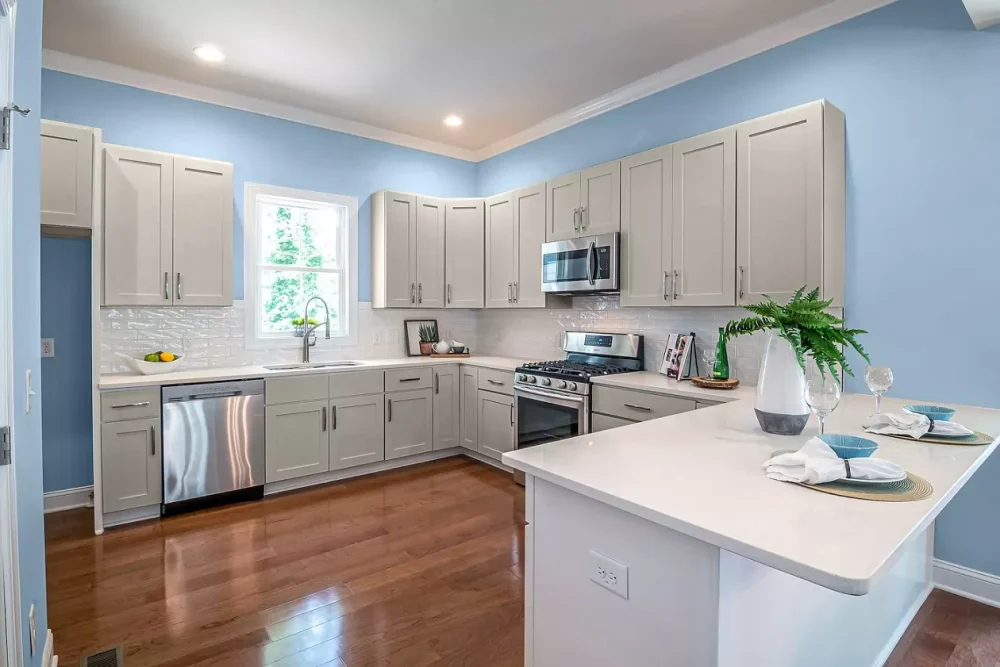 Blue wall goes with gray kitchen cabinets