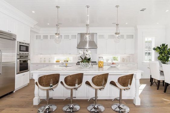 White quartz kitchen island with adjustable height bar stools
