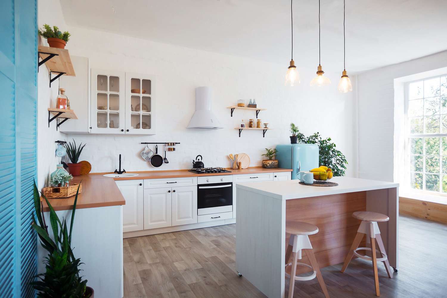 Bright kitchen with well-maintained particle board kitchen cabinets and wooden countertops