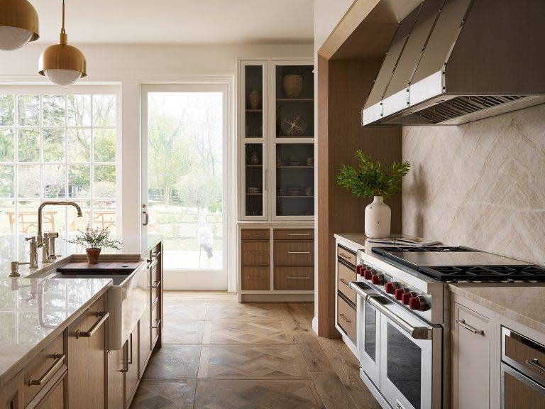 kitchen with cohesive color palette, featuring matte black cabinet doors, light beige floor, and taupe walls