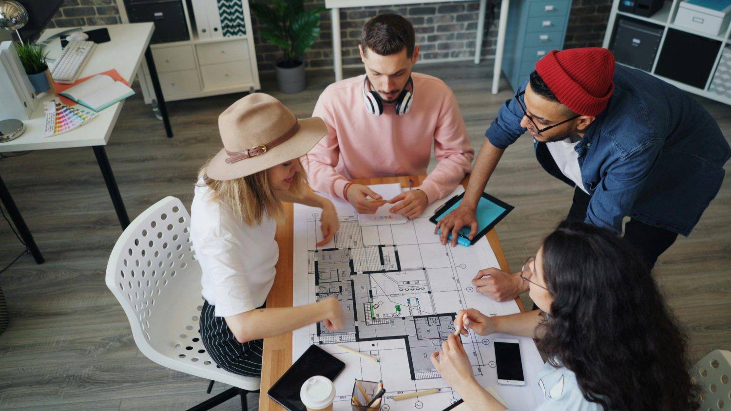 Team collaborating on window designs and installation plans, ensuring clear communication with the window manufacturer.