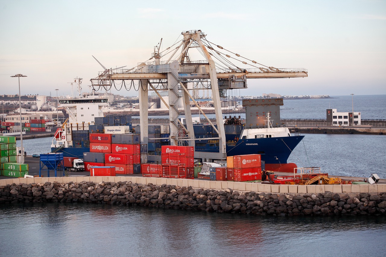 Shipping containers at a port, symbolizing the logistics and shipping process for factory-direct windows.