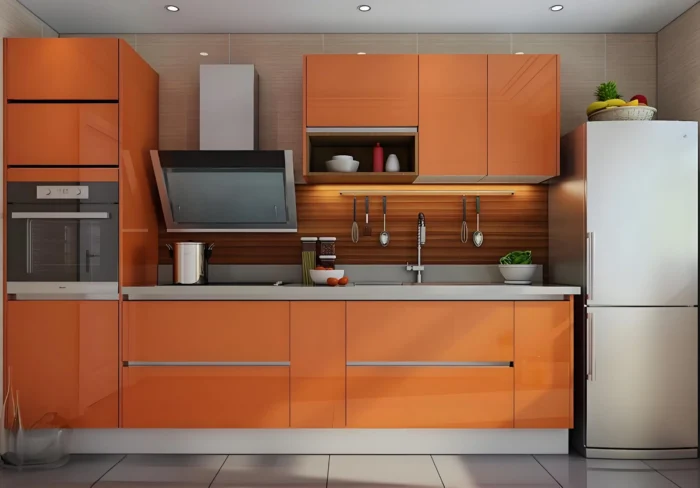 Combine gabinetes de color naranja con electrodomésticos de acero inoxidable