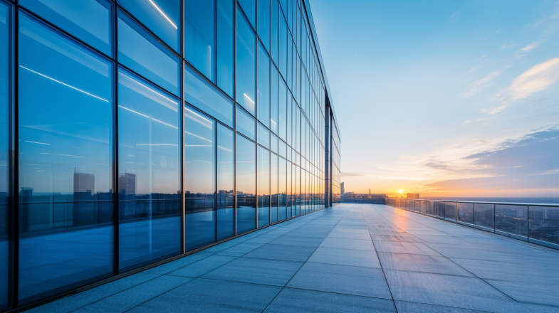 Modern office building with sleek glass windows, designed to optimize natural light and energy efficiency.
