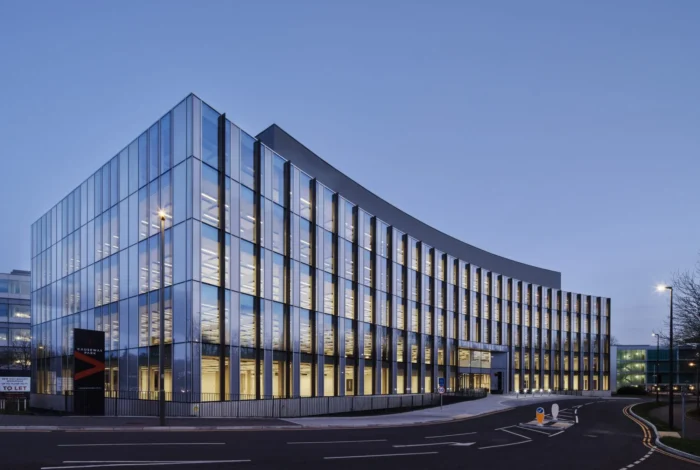 Modern office building under construction with glass facades and flexible workspace design.
