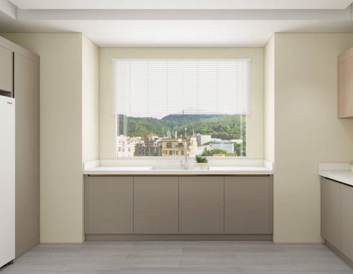 Minimalist kitchen with greige cabinets, white countertops, and a large window for natural light