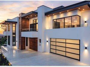 Modern home exterior with a sleek, durable garage door, featuring stylish black and white design, large windows, and contemporary architecture