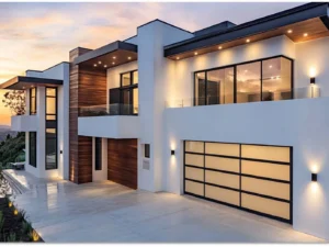 Modern home exterior with a sleek, durable garage door, featuring stylish black and white design, large windows, and contemporary architecture