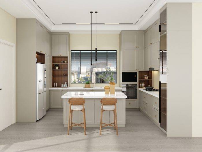 Greige kitchen cabinets with brass hardware, white countertops, and wood accents in a modern classic kitchen