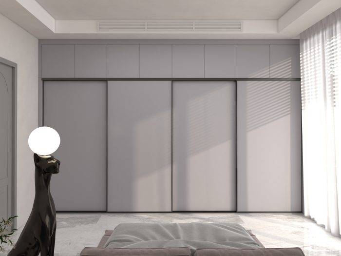 Sliding door wardrobe in a modern bedroom with neutral tones