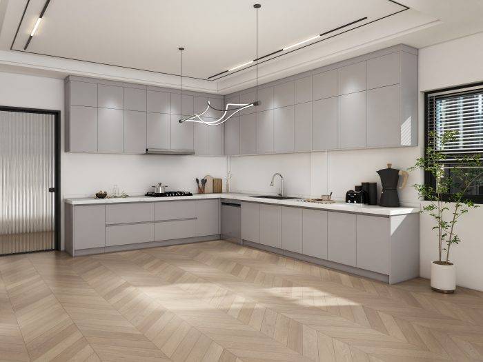 Sleek floating greige kitchen cabinets with white countertops, minimalist design, and wood flooring for a modern look