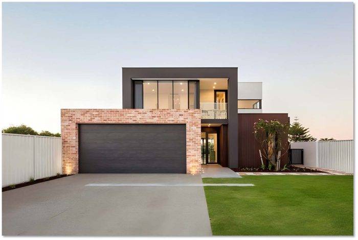 Modern home exterior featuring a sleek, fashionable garage door with a textured finish, paired with contemporary architectural elements and landscaped surroundings.