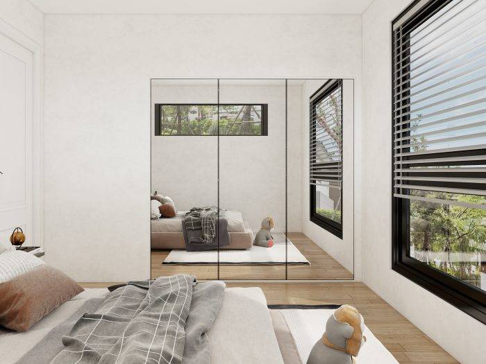 Modern wardrobe design for bedroom with mirror panels reflecting the room