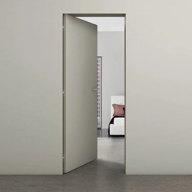 Modern invisible interior door with a seamless flush design, featuring concealed hinges and a minimalist aesthetic, blending perfectly into the surrounding wall.