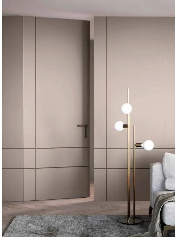 Modern beige invisible interior door seamlessly integrated into a minimalist wall design, featuring a flush finish and a sleek handle for a sophisticated look.