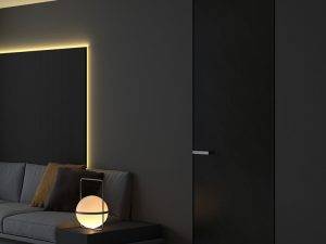 Modern black invisible interior door with a seamless flush design, featuring a sleek handle and integrated into a minimalist dark-toned living space.