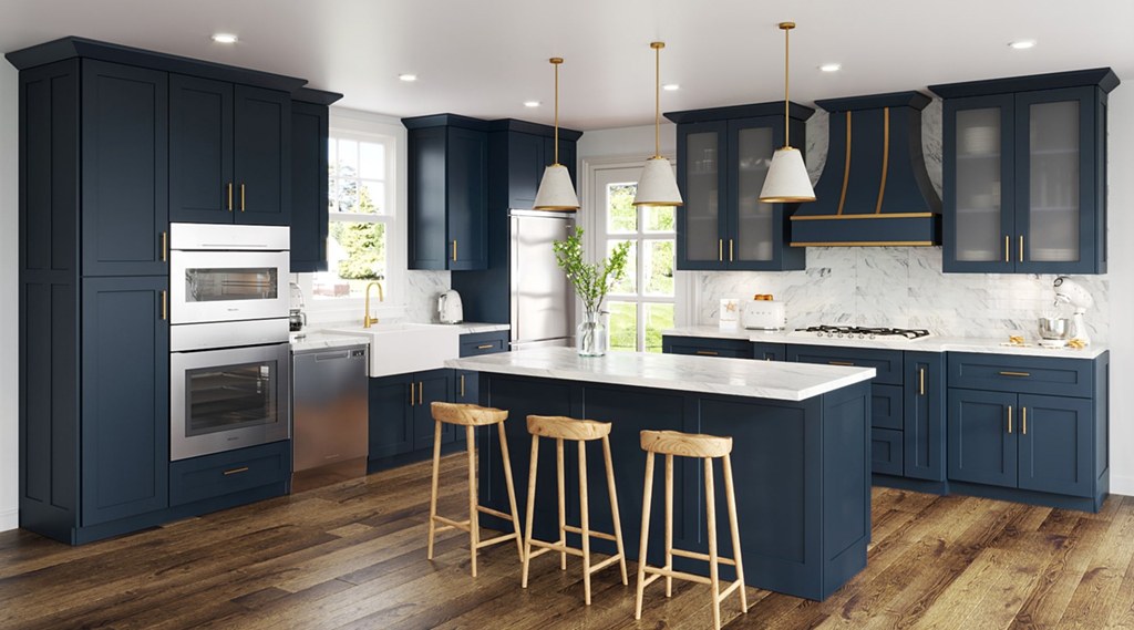 Kitchen featuring top-rated RTA cabinets in navy with brass hardware and modern design