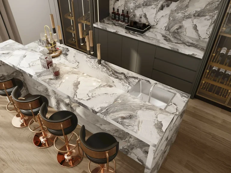 Modern kitchen featuring a luxurious marble countertop material with stylish bar stools and dark cabinetry.