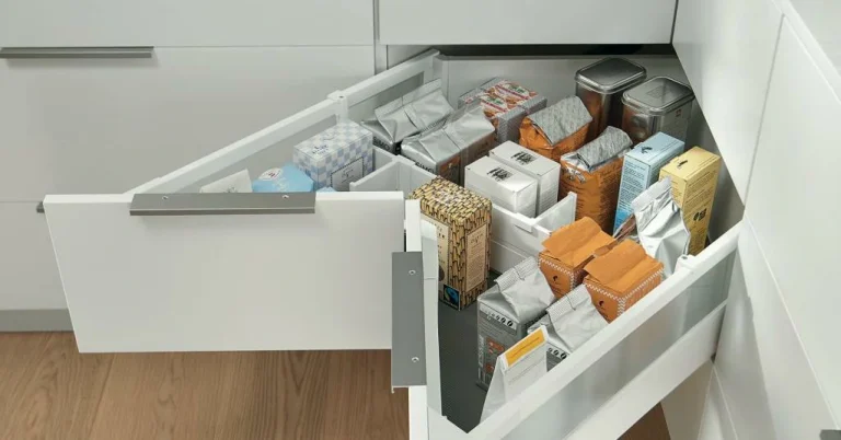 Blind corner drawer system for easy access, organizing packaged items in a kitchen cabinet.