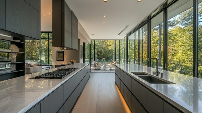 Modern SieMatic kitchen with grey cabinets, marble countertops, and natural light, showcasing premium kitchen investment value.