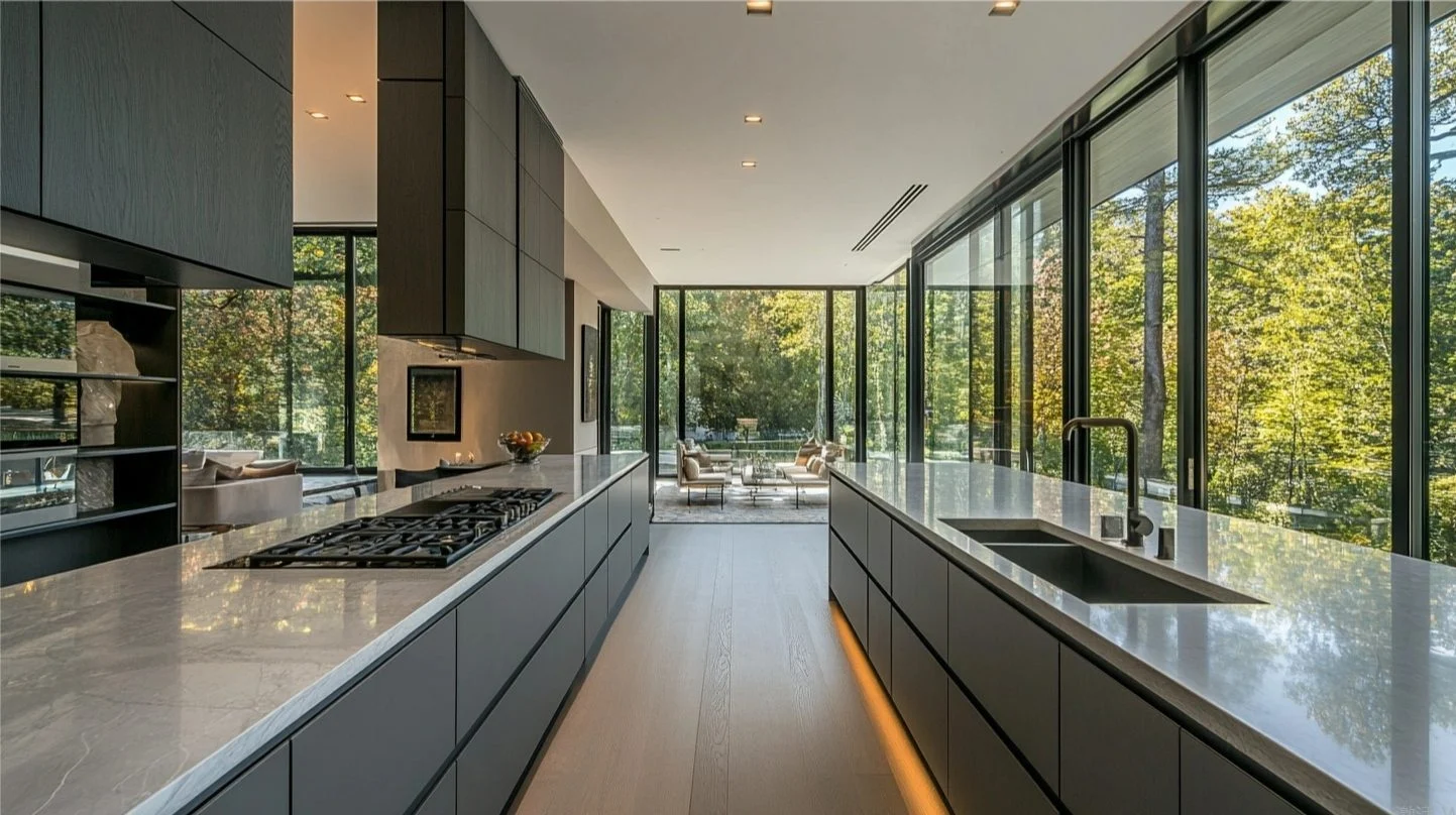 Modern SieMatic kitchen with grey cabinets, marble countertops, and natural light, showcasing premium kitchen investment value.