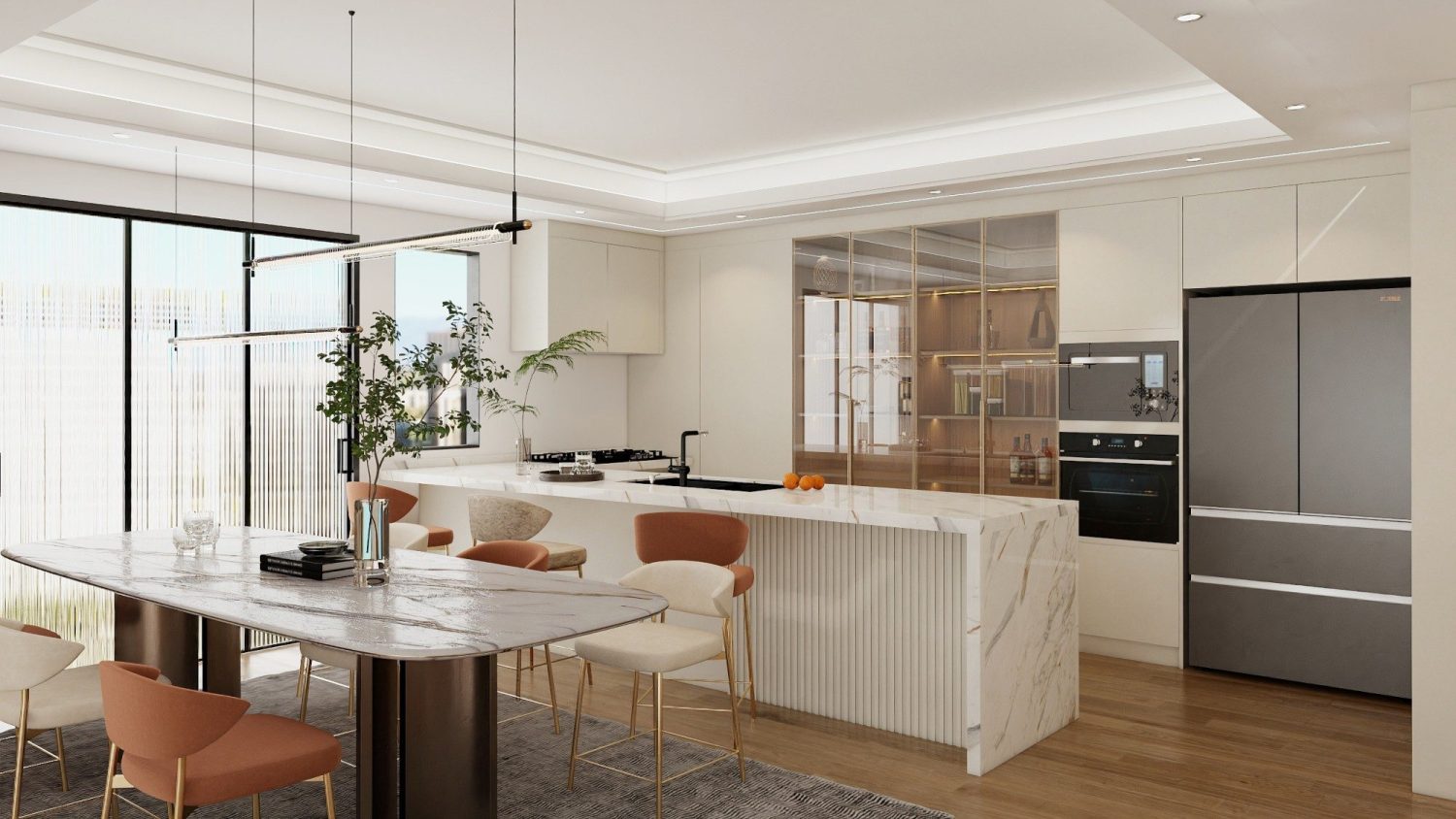 Beige gloss and wood-veined cabinets surrounding a marble waterfall island with integrated sink, gold-tone accents, and dining table