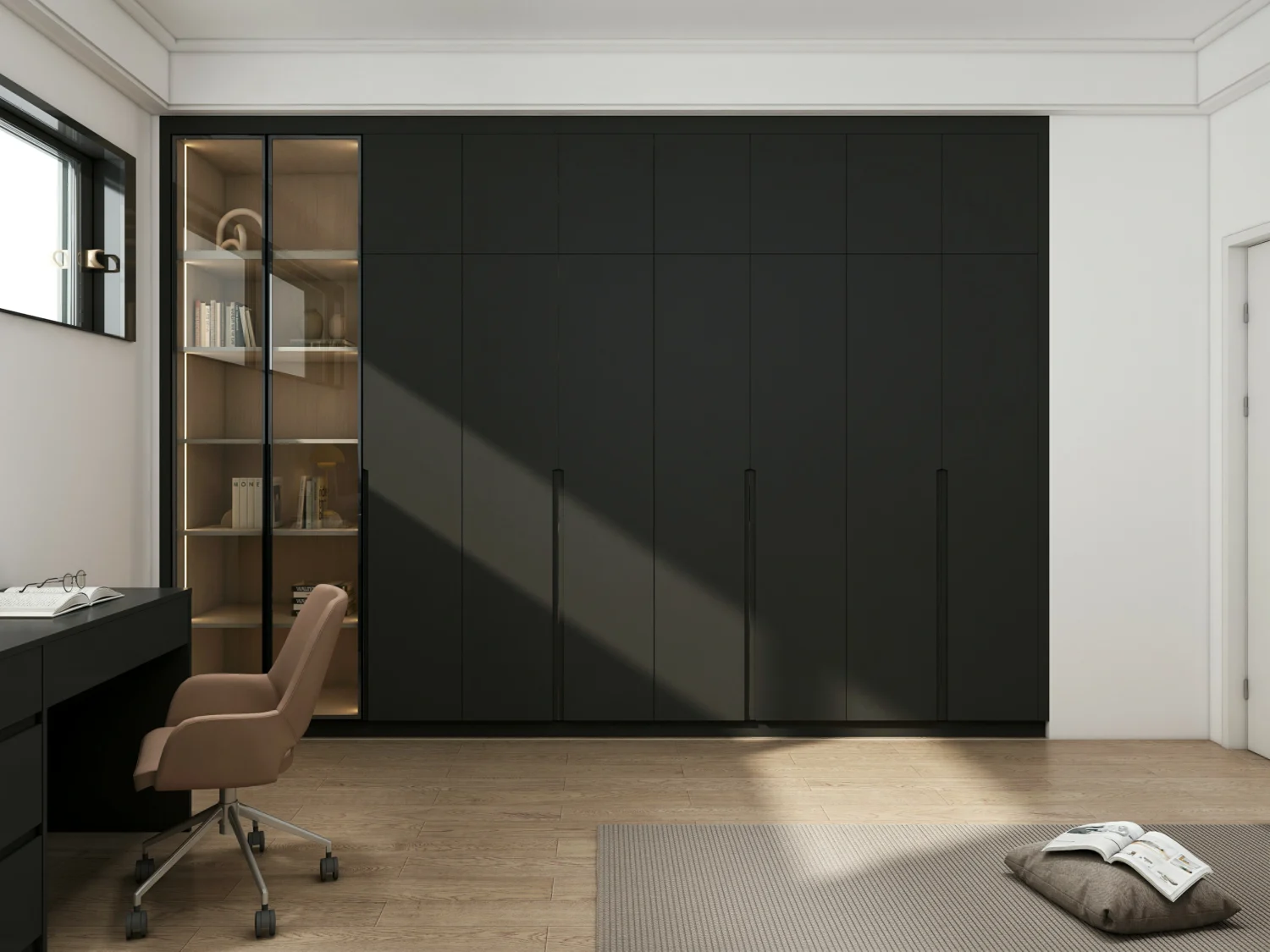A black wardrobe designed for a small bedroom, with sleek, space-saving sliding doors.