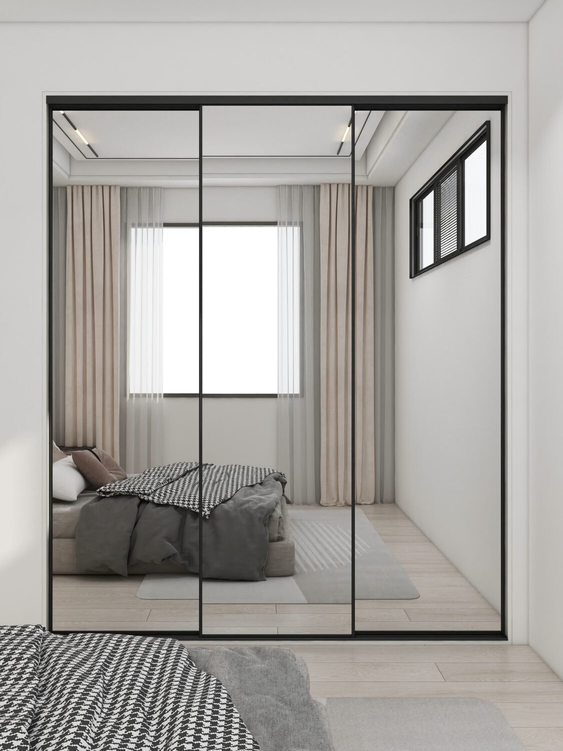 Modern built-in wardrobe with sliding mirror doors and black frames, reflecting the bedroom interior.