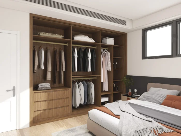 Wooden built-in wardrobe with hanging space, shelves, and drawers in a contemporary bedroom design.