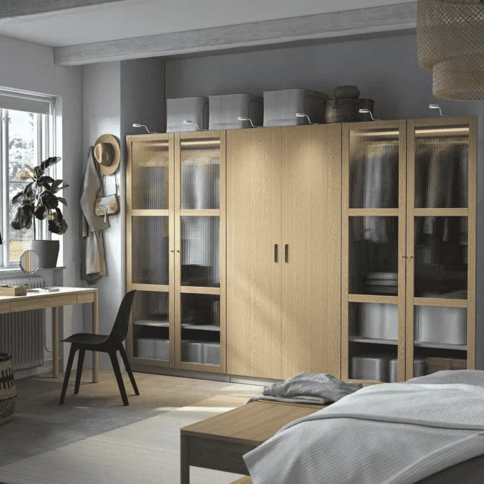 IKEA oak wardrobe with glass doors and open shelving, combining classic wood with modern transparency.