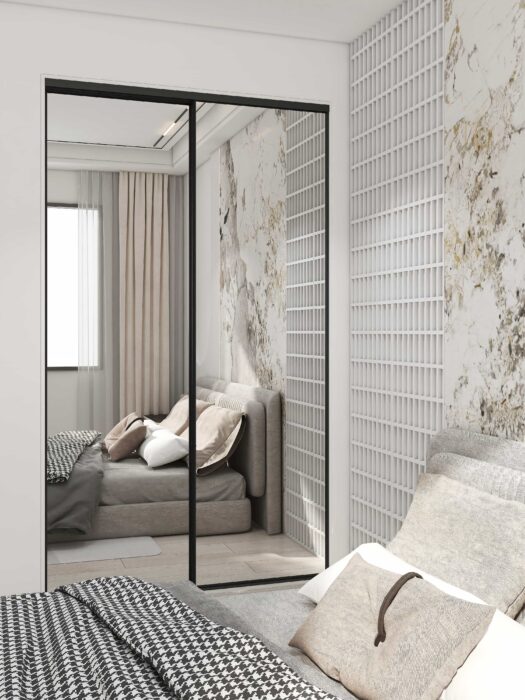 Full-length mirrored double closet doors reflecting a bright, spacious bedroom interior.