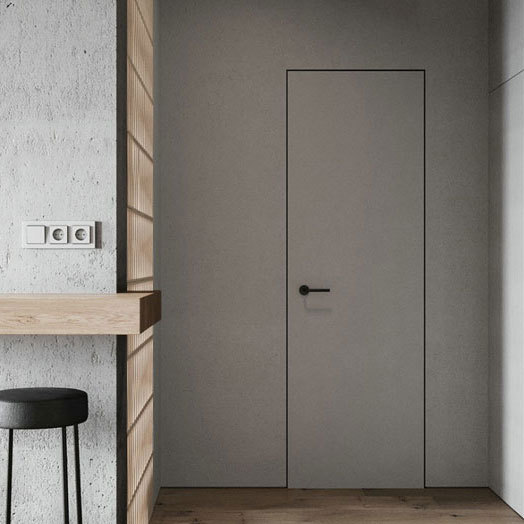 Modern wooden interior door in minimalist gray design blending with concrete wall and bar counter.