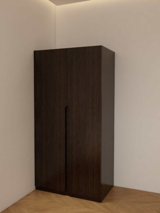 Rich wood traditional double closet doors with raised paneling and classic brass handles.