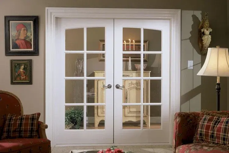 White aluminium framed French door with glass panels showing standard interior door size in a living room.