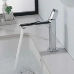 Sleek chrome bathroom faucet with modern design flowing water into a white sink