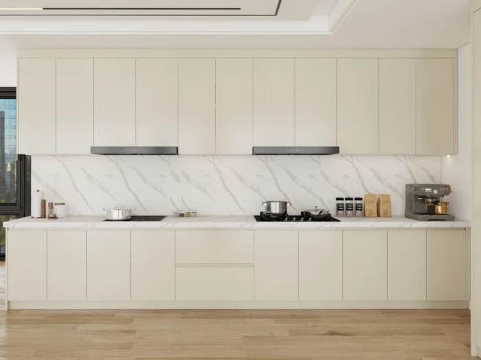 Light beige kitchen featuring Thermofoil cabinet doors and a marble backsplash, blending elegance and simplicity.