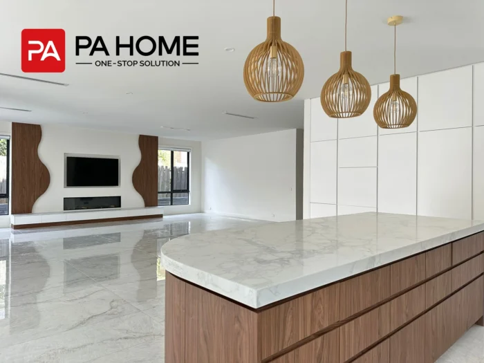 A white and walnut Melbourne kitchen using Y111 wood-grain cabinetry, L3110B lacquer panels, and marble-look surfaces for a quiet luxury interior.